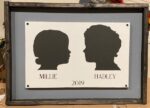 14x24 Framed Double Silhouette- $100 After checkout send a clear side view photo of your family members on a plain and preferably white background. We also recommend a photo without a bow. Don't forget to provide the names and the year the photo was taken in the project detail box.